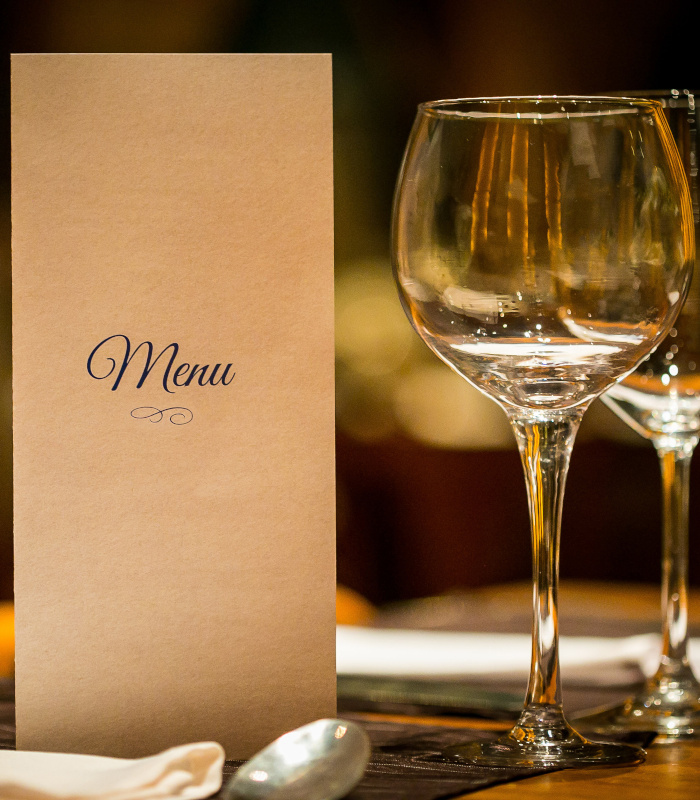 Restaurant menu and wine glasses