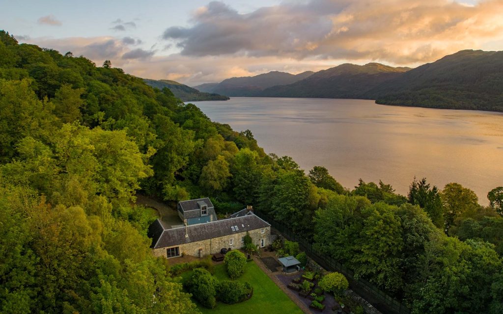 Stucdarach aerial view with Loch Lomond at sunset next to it