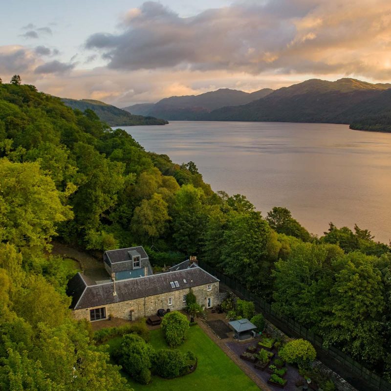 Stucdarach aerial view with Loch Lomond at sunset next to it