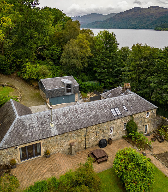 An aerial view of Stuckdarach house with Loch Lomond in the background