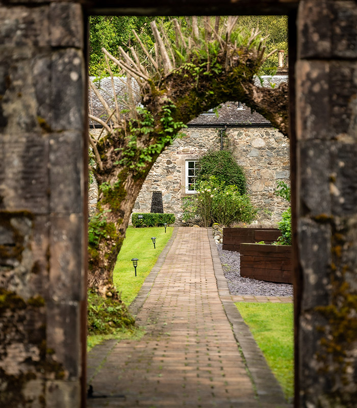 Looking through the garden walls up to Stuckdarach house by Loch Lomond