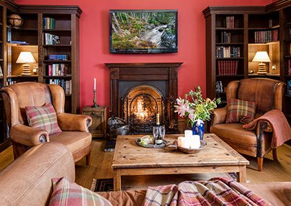 The library with a roaring fire in Stucktaymore house by Loch Tay