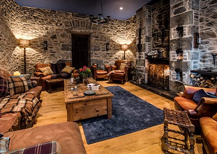 The old stone walled sitting room with an open fire in Stucktaymore house by Loch Tay