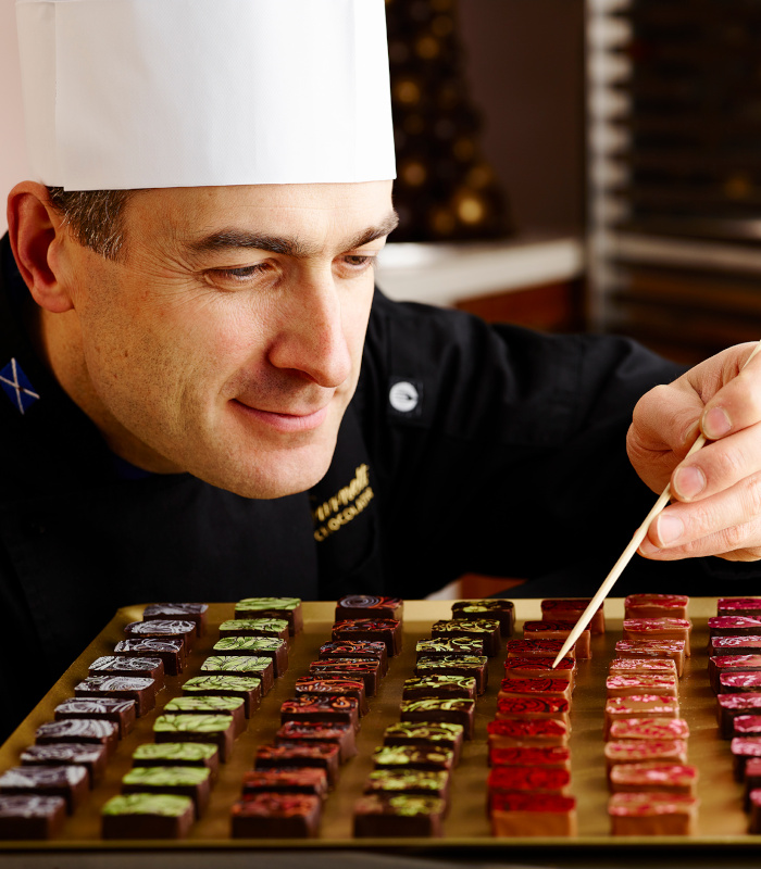 Iain Burnett performing a quality check on chocolates