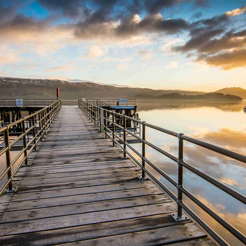 Sun rise above the pier at the picturesque village of Luss, on Loch Lomond