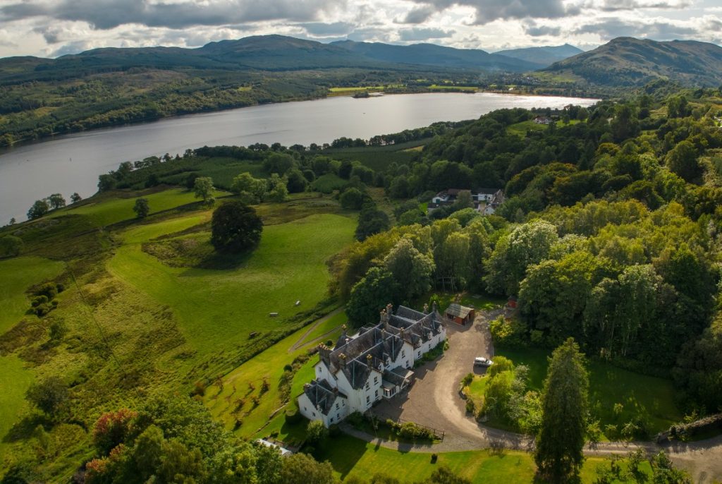 A drone photo of our big Scottish country house Stucktaymore on the banks of Loch Tay
