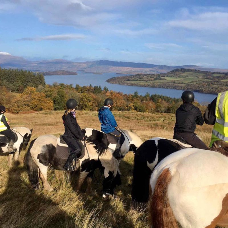 Pony trekking group looking out across Loch Lomond