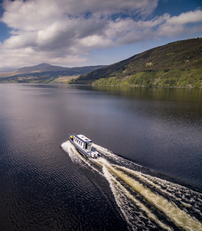 Aerial view of boat sailing across Loch Tay, Scotland