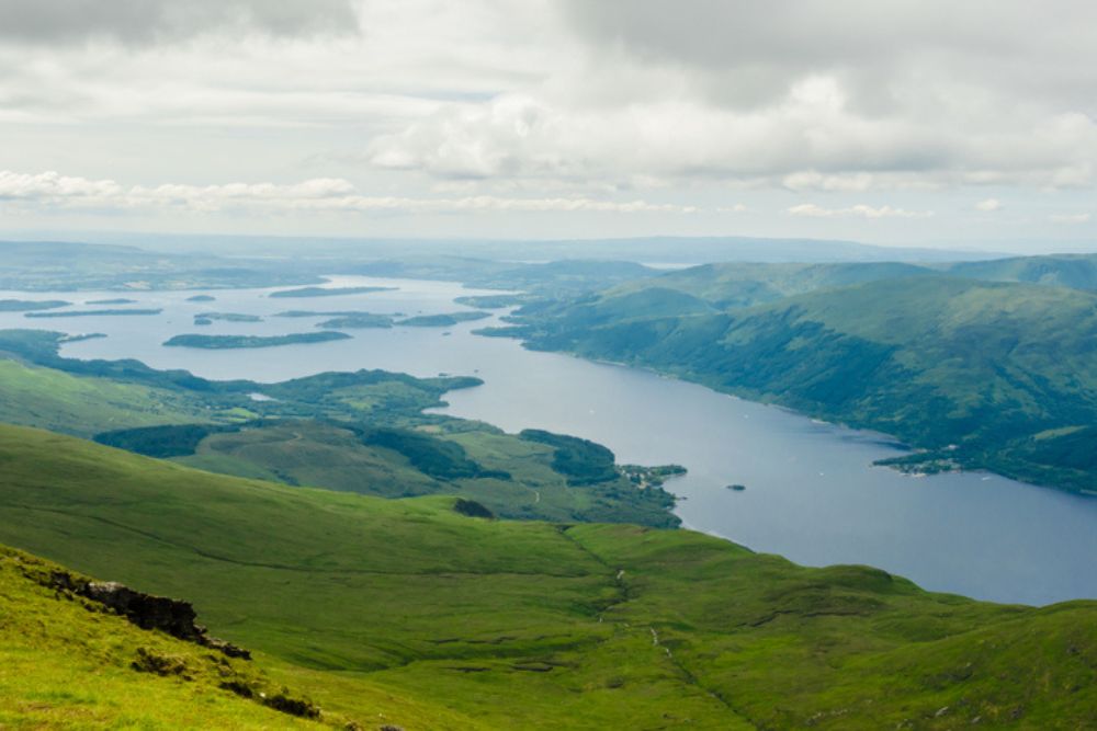 View of Loch Lomond from the top of Ben Lomond on a sunny day. 