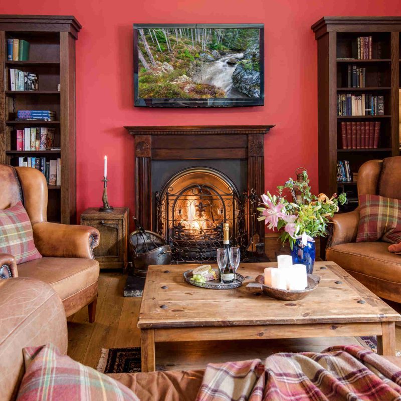 The library with a roaring fire in Stucktaymore House by Loch Tay