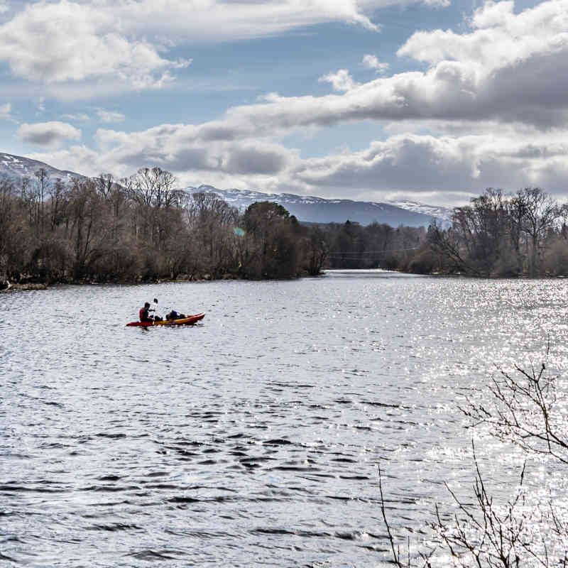 A family kayaking on Loch Tay