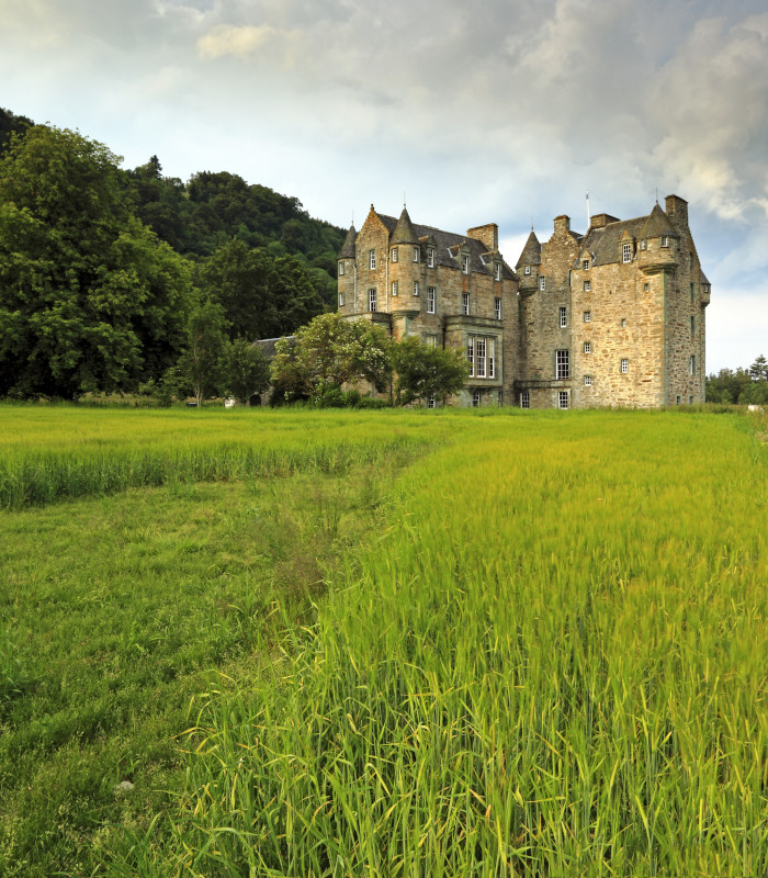 View over grass towards Castle Menzies in Scotland