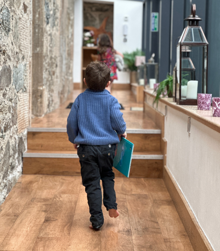 Boy running through the hall at Stuckdarach holiday house