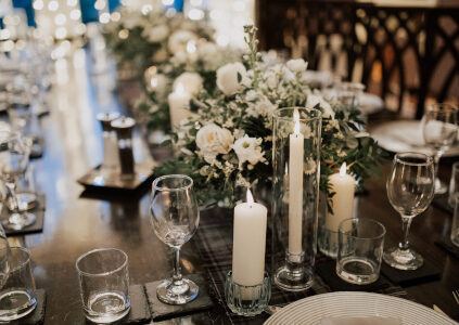 Tables decorated with flowers and candles for a wedding