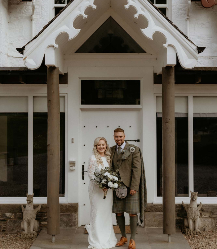 A bride and groom outside the entrance to Stucktaymore next to Loch Tay